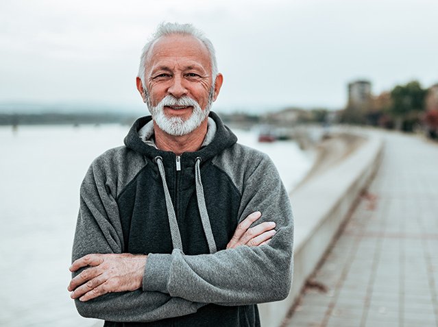Portrait of a active senior in sportswear by the river.